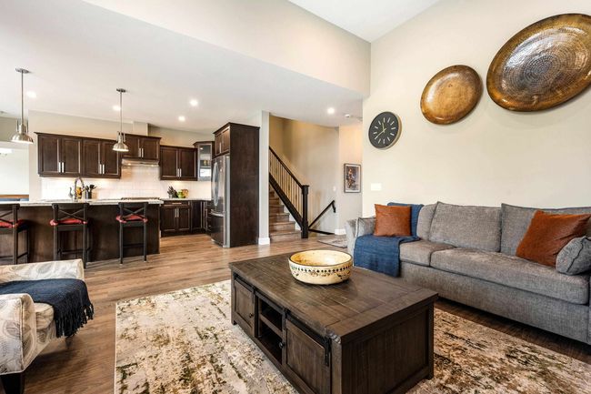 Living room with recessed lighting, light wood-style flooring, and stairway | Image 13