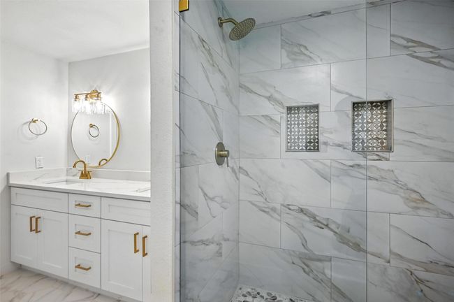 Primary bedroom is spacious with a walk in shower, 2 niches, dual vanities and a walk in closet. | Image 18