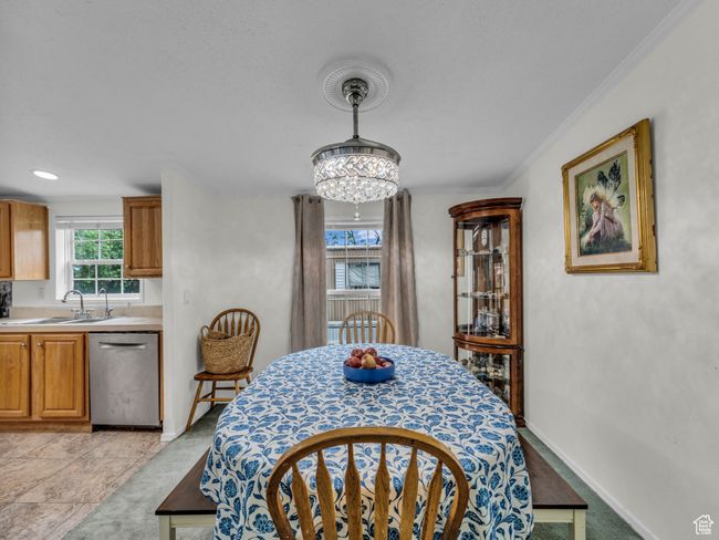 Dining space featuring ornamental molding, a chandelier, and baseboards | Image 18