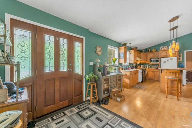 Entrance foyer with light wood-style flooring and vaulted ceiling | Image 21