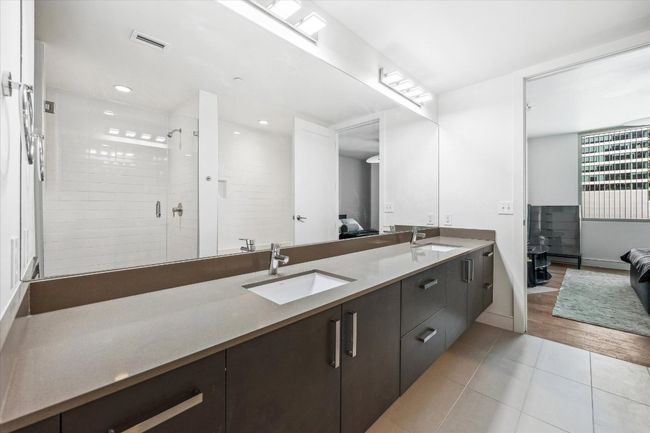 Ensuite bathroom featuring visible vents, a sink, double vanity, connected bathroom, and tile patterned flooring | Image 8