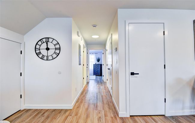 Corridor with light wood finished floors and baseboards | Image 12