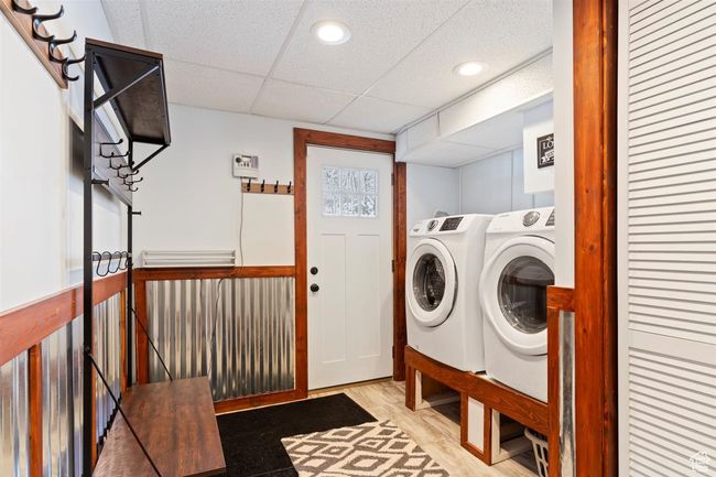 Clothes washing area with separate washer and dryer, recessed lighting, and wood finished floors | Image 30