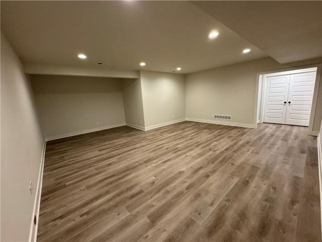 Finished below grade area with recessed lighting and wood finished floors | Image 53
