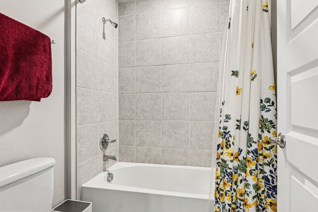 Bathroom with shower / bath combination with curtain and toilet | Image 26