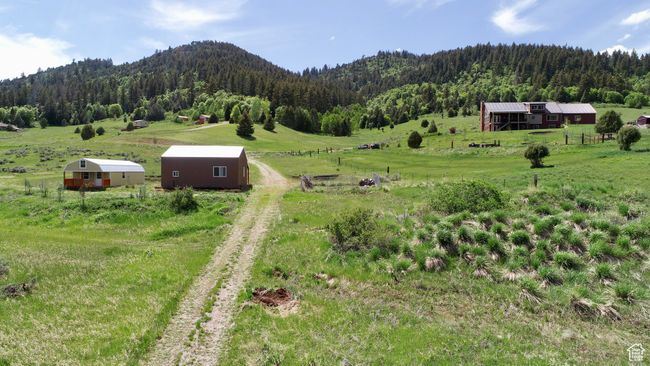 View of mountain backdrop featuring a heavily wooded area and rural landscape | Image 10