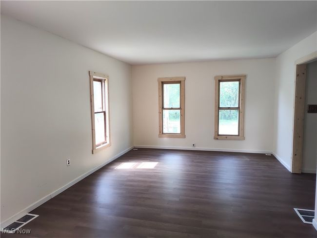 Spare room with dark wood finished floors and baseboards | Image 18