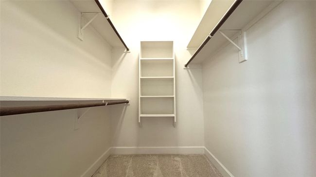 Walk in closet with carpet floors | Image 10