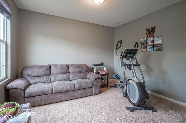 workout room featuring carpet and baseboards | Image 26