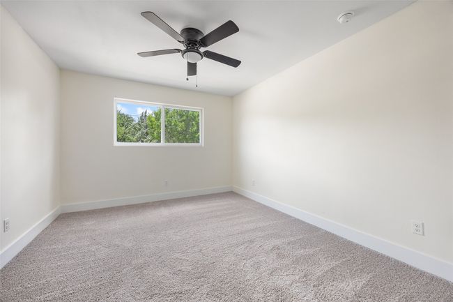 Empty room featuring light colored carpet and a ceiling fan | Image 33