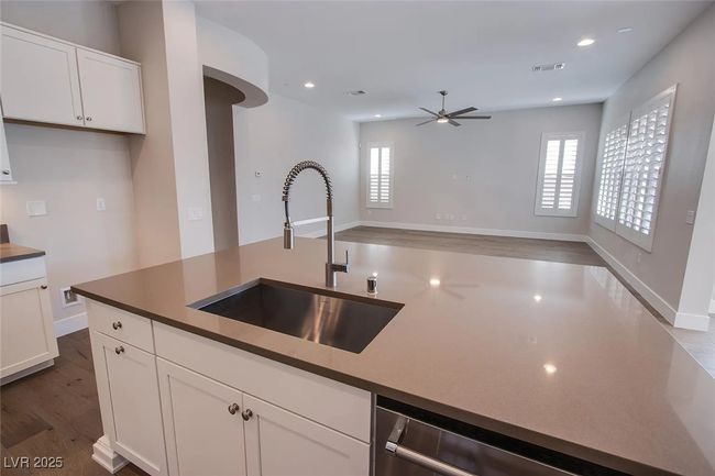 Kitchen with a ceiling fan, a sink, a wealth of natural light, and visible vents | Image 5