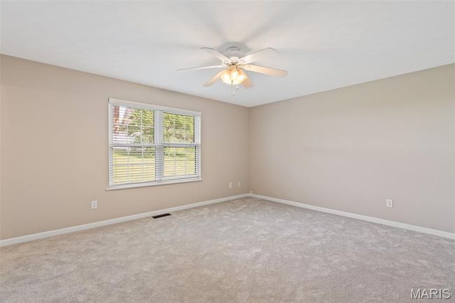Empty room featuring a ceiling fan, carpet, and baseboards | Image 13