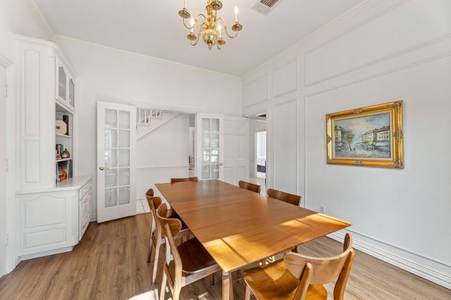 Dining room with a chandelier, ornamental molding, luxury vinyl planking flooring | Image 12