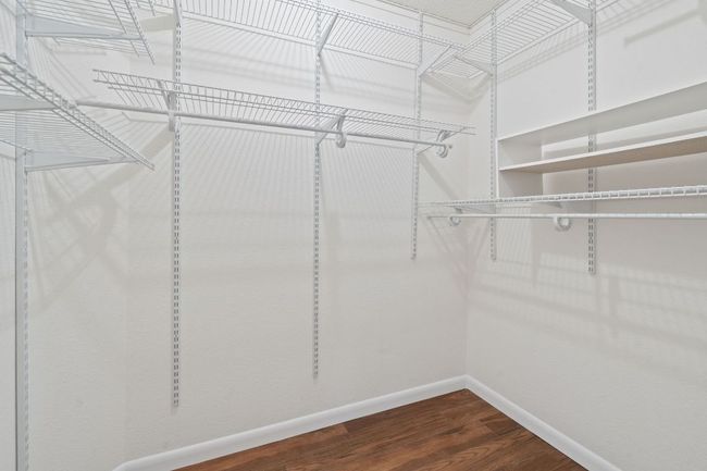 One of two primary closets, this walk-in offers excellent storage space. | Image 25