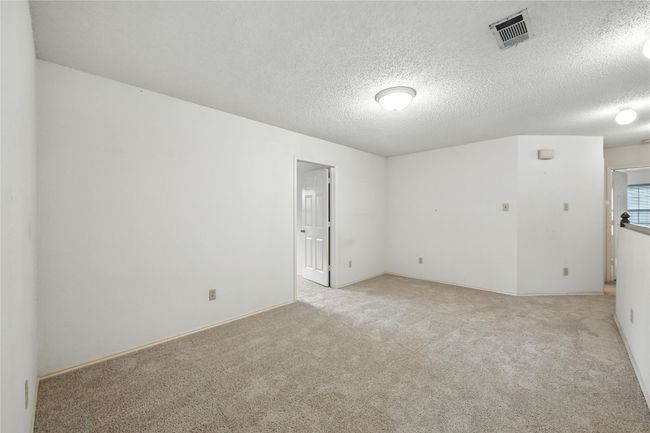 Empty room with light carpet and a textured ceiling | Image 26