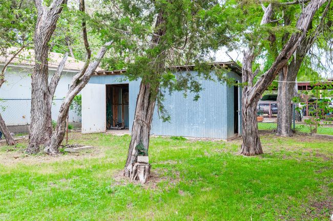 Rear view of house featuring a yard, fence, and an outbuilding | Image 29