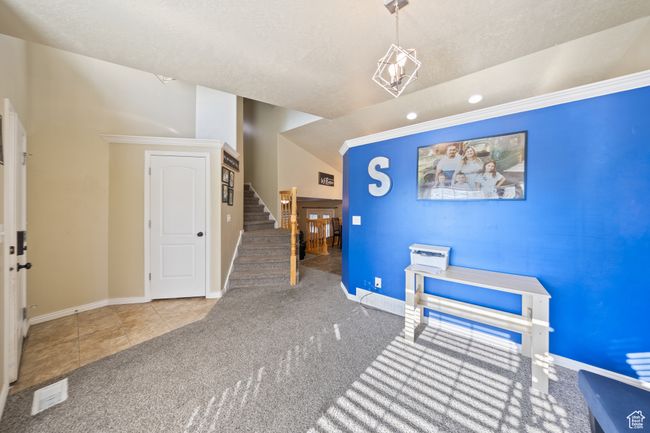 Carpeted dining area featuring stairway, tile patterned flooring, recessed lighting, and ornamental molding | Image 4