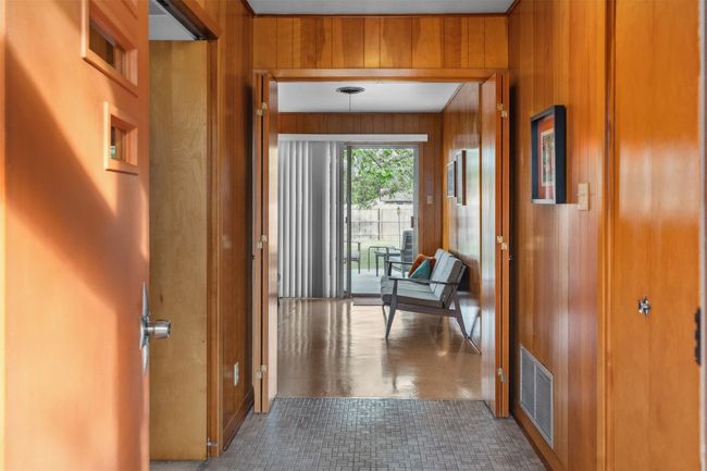 Entry corridor with wood stained walls and trim | Image 8