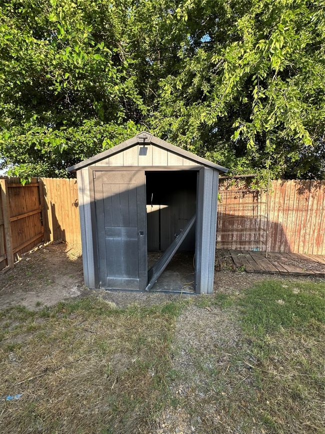 View of shed featuring a fenced backyard | Image 35