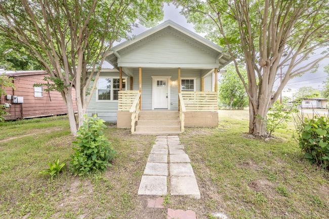 Bungalow-style house with a front yard and covered porch | Image 28
