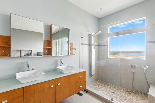 Bathroom featuring a walk in shower and double vanity | Image 18