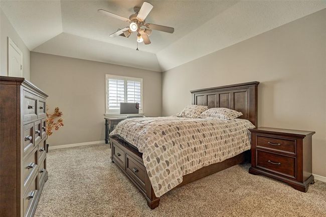 Upstairs third bedroom featuring elegant plantation shutters. | Image 18
