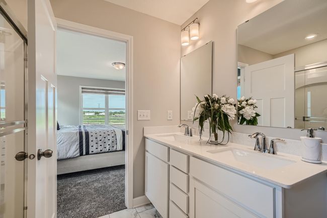Photo is of the model. Primary private bath with double-vanity and a separate shower. | Image 14