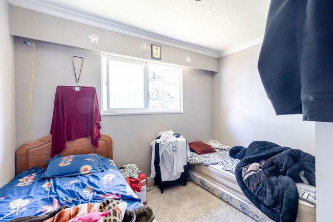 Carpeted bedroom with ornamental molding | Image 17