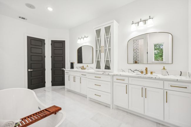 Bathroom with double vanity, a freestanding tub, and recessed lighting | Image 17
