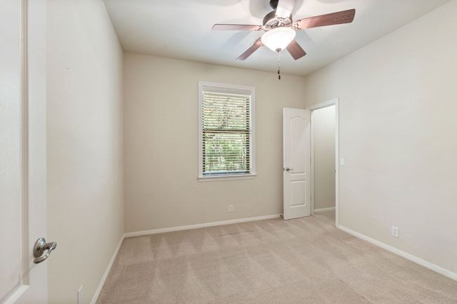 Spare room featuring light colored carpet and ceiling fan | Image 18