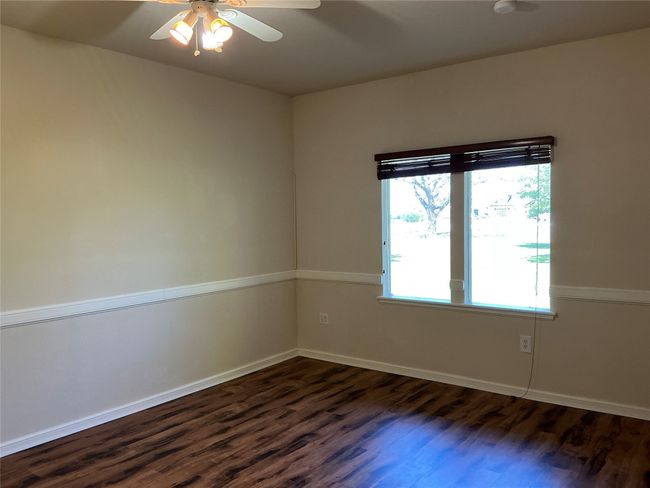 Spare room featuring baseboards, a ceiling fan, and dark wood-style floors | Image 18