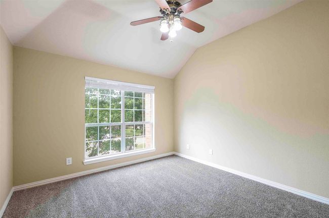 Carpeted spare room with a ceiling fan, vaulted ceiling, and baseboards | Image 18