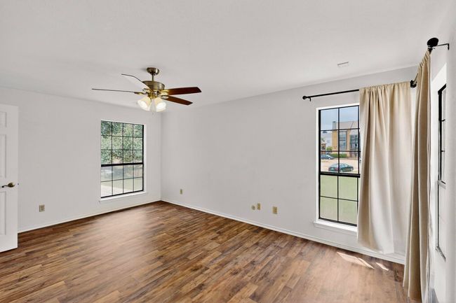 Spare room with wood finished floors, ceiling fan, and baseboards | Image 28