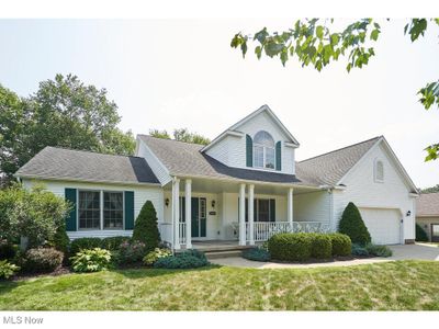 View of front of house featuring a garage, a porch, and a front yard | Image 2