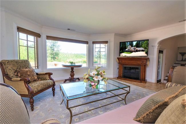 Living room has a fabulous view, Pella windows with automatic shades. Travertine floor. Large opening to the kitchen and 2 sliding doors to 2 different patios! | Image 19