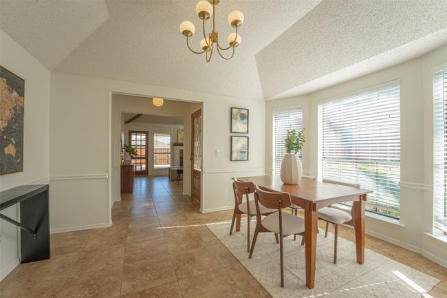 Dining area featuring chandelier, and vaulted ceiling | Image 14