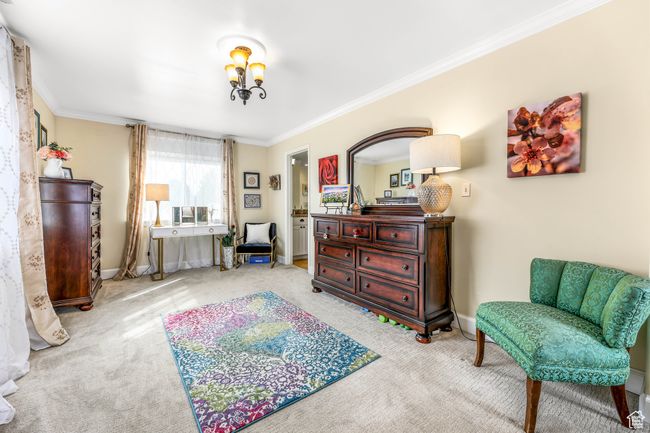 Sitting room with carpet floors, an inviting chandelier, baseboards, and crown molding | Image 26