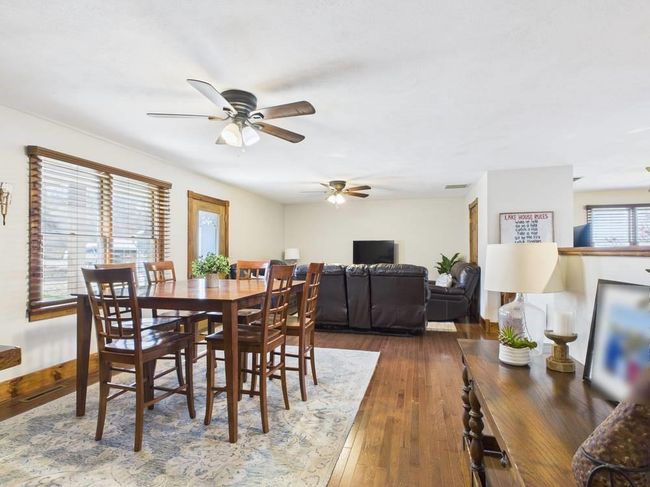 View from primary bedroom of dining space with visible vents, wood flooring, ceiling fan, and baseboards | Image 29