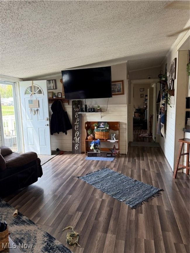 Living room featuring wood finished floors and a textured ceiling | Image 4