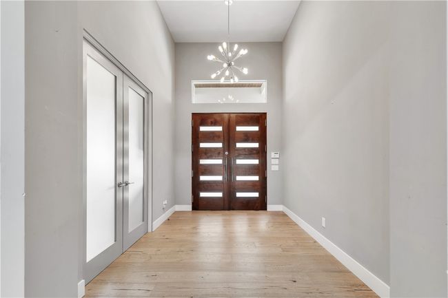 Entrance foyer featuring a chandelier, light wood-style flooring, and a high ceiling | Image 4