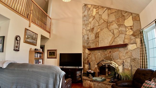 Living room featuring wood finished floors and a fireplace | Image 39