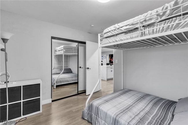 Bedroom with a closet and wood finished floors | Image 26