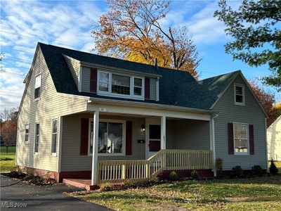 View of front of house featuring a front lawn and covered porch | Image 1