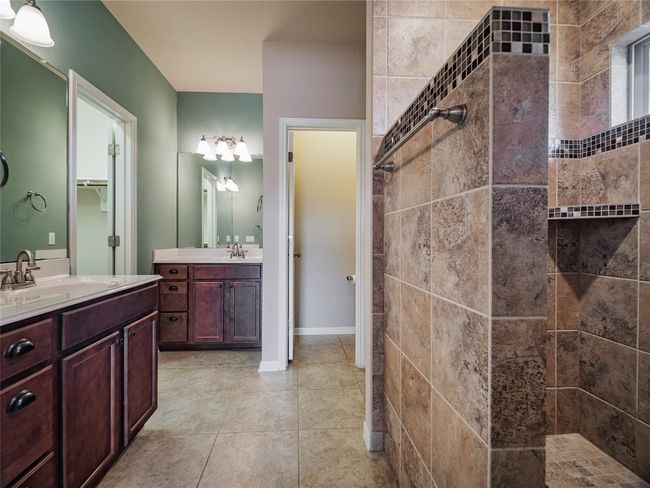 Full bathroom with walk in shower, two vanities, and tile patterned floors | Image 25