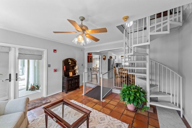 Living area featuring baseboards, stairs, ornamental molding, and ceiling fan | Image 12