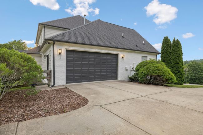 Two car garage with zero step access to the main level. There is an additional 1 car garage on the other side with access to the lower level. | Image 25