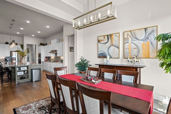 Dining room featuring dark wood finished floors and recessed lighting | Image 16