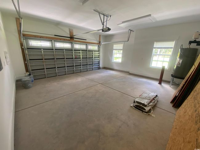 Garage with water heater and a garage door opener | Image 35