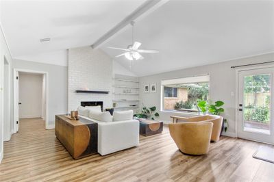 Spacious family room with soaring ceilings and expansive picture window. | Image 1