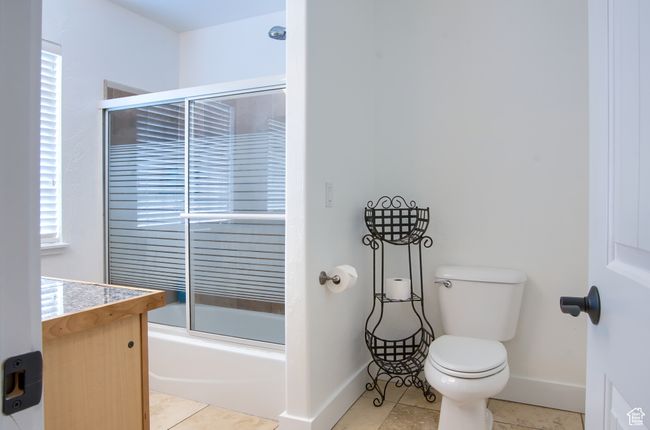 Full bathroom featuring baseboards, toilet, and combined bath / shower with glass door | Image 32